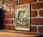 A vintage-style metal sign with a black marlin fish illustration and text, mounted on a brick wall.
