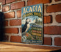 A vintage metal sign for the Acadia Birding Trail in Maine, featuring a puffin bird and various trail information.