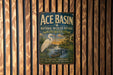 A vintage metal sign for Ace Basin National Wildlife Refuge in South Carolina, featuring an illustration of a white egret and a crocodile in a tropical setting.