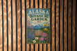 A vintage-style metal sign for the Alaska Botanical Garden, featuring colorful illustrations of flowers and plants.