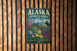 A vintage-style metal sign for the Alaska Botanical Garden, featuring a colorful illustration of various plants and flowers.