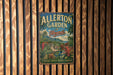 A vintage metal sign for Allerton Garden in Hawaii, featuring a tropical landscape with palm trees, flowers, and a tropical waterfall.