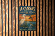 A vintage metal sign for the Arkansas National Wildlife Refuge in Texas, featuring an illustration of a bird and a turtle against a sunset backdrop.