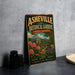 A vintage-style metal sign for the Asheville Botanical Gardens in North Carolina, featuring a colorful illustration of a garden with flowers and a dome-shaped building.