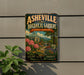 a vintage-style sign for the Asheville Botanical Gardens in North Carolina, with a lush garden scene and a building with a dome in the background.