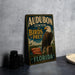 A vintage-style sign for Audubon Center for Birds of Prey in Florida, featuring an eagle perched on a tree branch.
