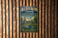 A vintage metal sign for Audubon Center in Greenwich, Connecticut, featuring a blue background with a bird illustration and text promoting nature, education, and conservation.
