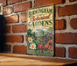 A vintage-style sign for the Birmingham Botanical Gardens in Alabama, featuring illustrations of flowers and a building with a dome.