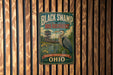 A vintage-style metal sign for the Black Swamp Bird Observation in Ohio, featuring a large blue heron and a wooden structure in the background.