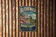 A vintage-style metal sign for Blithwold Mansion Gardens in Rhode Island, featuring a house surrounded by lush gardens and flowers.
