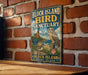 A vintage-style metal sign for the Block Island Bird Sanctuary in Rhode Island, featuring an illustration of an owl and a lighthouse.