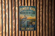 A vintage metal sign for the Bombay Hook National Wildlife Refuge in Delaware, featuring an illustration of a heron and the text "A Haven for Wildlife".