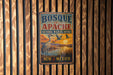 A vintage metal sign for Bosque de Apache National Wildlife Refuge in New Mexico, featuring an illustration of a crane and a sunset over a lake.