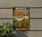 A vintage-style metal sign for the Boyce Thompson Arboretum in Arizona, featuring a desert landscape with cacti and other desert plants.