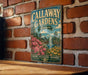 A vintage metal sign for Callaway Gardens in Georgia, featuring a scenic landscape with a fountain and flowers, mounted on a brick wall.