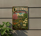 A vintage-style metal sign for Cheekwood Estate & Gardens in Tennessee, featuring a colorful illustration of a garden with a house and flowers.