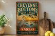 A vintage-style sign for Cheyenne Bottoms Wetlands in Kansas, featuring an illustration of a bird and a sunset over a body of water.