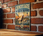 A vintage-style metal sign for the Chincoteague National Wildlife Refuge in Virginia, featuring an illustration of horses in a grassy field with a lighthouse in the background.