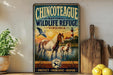 A vintage-style metal sign for the Chinook National Wildlife Refuge in Virginia, featuring an illustration of a horse and two birds in a natural setting.