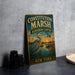 a vintage-style metal sign with a bird illustration, placed on a gray countertop next to some black camera lenses.