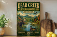 a vintage-style metal sign with a moose and a duck in a wildlife management area, surrounded by a forest and a river.