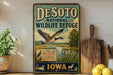 A vintage-style metal sign for Desoto National Wildlife Refuge in Iowa, featuring a goose in flight and a sign that says "A Haven for Wildlife".