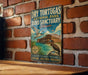 A vintage-style metal sign advertising Dry Tortugas National Park, Florida, with a bird illustration and text promoting the park's nature, remote paradise, and wildlife.