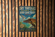 A vintage-style metal sign for Dry Tortugas National Park Bird Sanctuary in Florida, featuring a bird illustration and text promoting the park's nature reserve and remote tropical paradise.