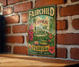 A vintage-style metal sign for the Fairchild Tropical Botanic Garden in Florida, featuring colorful illustrations of tropical plants and flowers.