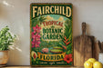 a vintage-style sign for the Fairchild Tropical Botanic Garden in Florida, with a tropical garden scene and various plants and flowers.