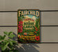 a vintage-style metal sign with a tropical garden theme, hanging on a wall.