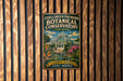 A vintage metal sign for the Foellinger-Freimann Botanical Conservatory in Indiana, featuring a garden scene with a greenhouse and flowers.
