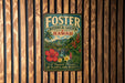 A vintage-style metal sign for Foster Botanical Garden in Hawaii, featuring a tropical landscape with palm trees, flowers, and a waterfall.