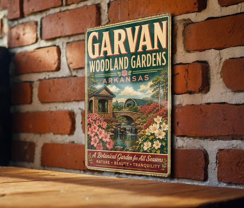 A vintage-style metal sign for "GARVAN WOODLAND GARDENS ARKANSAS" is displayed on a brick wall.