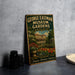 A vintage-style metal sign for the George Eastman Museum Gardens in Rochester, New York, featuring an illustration of a garden with a fountain and flowers.
