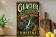 A vintage-style metal sign advertising the Glacier Garden in Montana, featuring a scenic image of a waterfall and a wooden bridge.