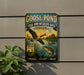 A vintage-style metal sign advertising the "Goose Pond Fish and Wildlife Area" in Indiana, featuring a goose in flight and a fish swimming in a pond.