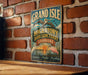 A vintage-style metal sign for the Grand Isle Migratory Bird Sanctuary in Louisiana, featuring illustrations of birds and a sunset.