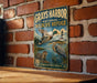 A vintage-style metal sign for the Grays Harbor National Wildlife Refuge in Washington, featuring illustrations of ducks, a heron, and a lighthouse.