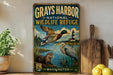 A vintage-style metal sign for the Grays Harbor National Wildlife Refuge in Washington, featuring illustrations of ducks, a heron, and a lighthouse.