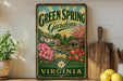 A vintage-style sign for "Green Spring Gardens" in Virginia, featuring a garden scene with flowers, trees, and a gazebo.