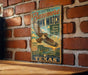A vintage-style metal sign with a hawk image and text, mounted on a brick wall.