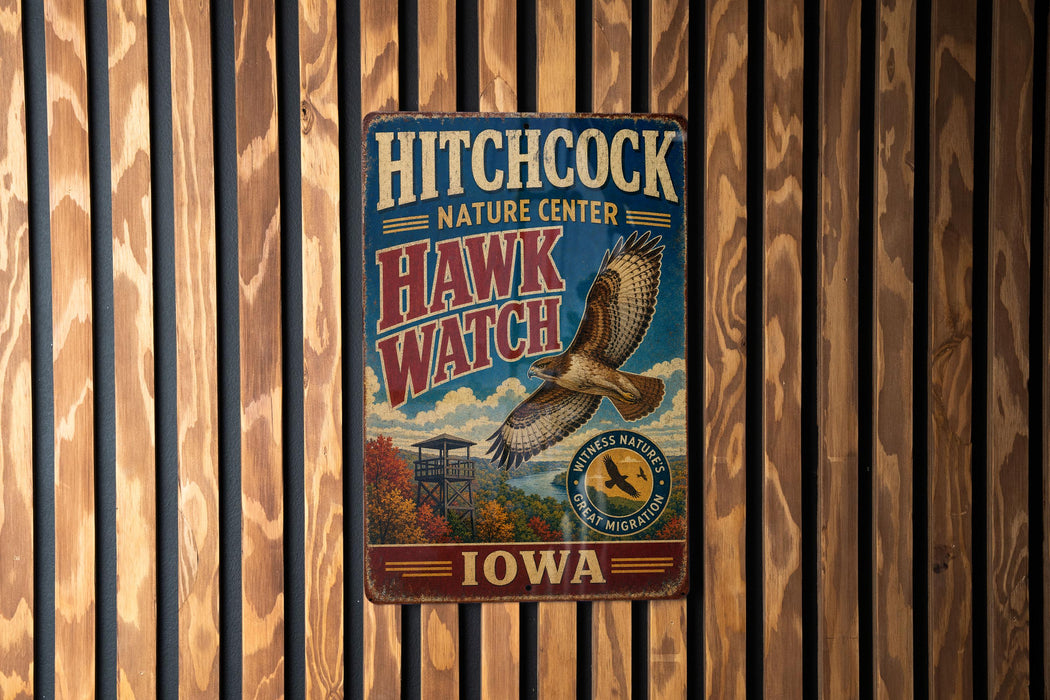 A vintage metal sign for the Hitchcock Nature Center in Iowa, featuring an illustration of a hawk in flight.