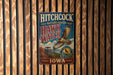 A vintage metal sign for the Hitchcock Nature Center in Iowa, featuring an illustration of a hawk in flight.