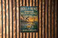A vintage metal sign for Holla Bend National Wildlife Refuge in Arkansas, featuring an illustration of ducks and a sunset landscape.