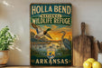 A vintage-style metal sign for Holla Bend National Wildlife Refuge in Arkansas, featuring illustrations of ducks and a sunset landscape.