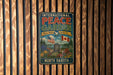 A vintage metal sign with the text "INTERNATIONAL PEACE GARDEN" and "NORTH DAKOTA" is displayed on a wooden fence.