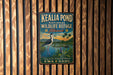 A vintage-style metal sign for the Kealia Pond National Wildlife Refuge in Hawaii, featuring an illustration of a bird and a tropical landscape.