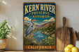 A vintage-style sign for Kern River Preserve in Audubon, California, featuring a heron standing on a rock in a scenic landscape.