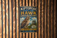 A vintage metal sign for Kiptope State Park's Hawk Observatory, featuring an illustration of a hawk and the text "A MIGRATION HOTSPOT ON THE CHESAPEAKE VIRGINIA".
